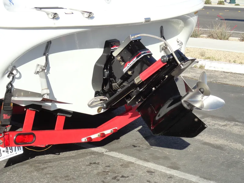 Slide: The Image of 1998 Baja Boss Hammer boat on red trailer, showing outboard motor and propeller. - 24