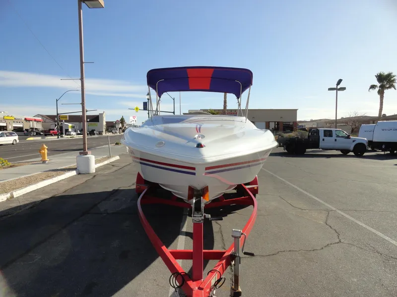 Slide: The Image of 1998 Baja Boss Hammer boat on a red trailer in a parking lot. - 3