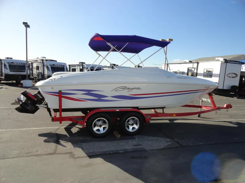 Slide: The Image of 1998 Baja Boss Hammer boat on a red trailer with a blue canopy. - 5