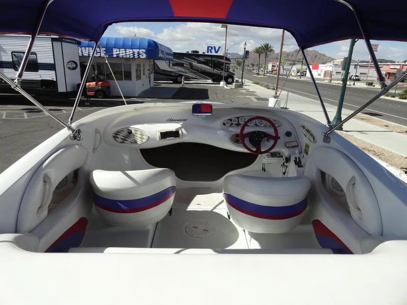 Slide: The Image of Interior of a 1998 Baja Boss Hammer boat with white and blue seating. - 6