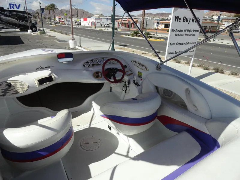Slide: The Image of 1998 Baja Boss Hammer boat interior with white and purple seats, red steering wheel. - 7