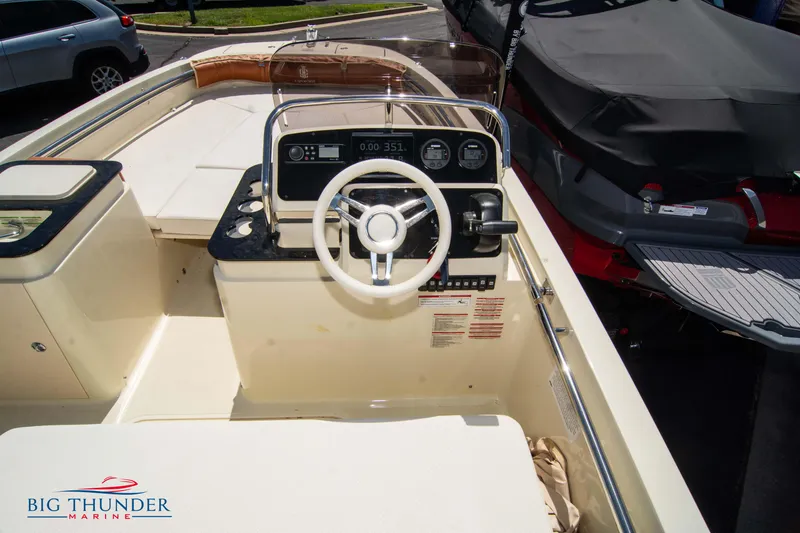 Slide: The Image of 2024 Capoforte SX200 boat interior with steering wheel and dashboard, displayed at Big Thunder Marine. - 15