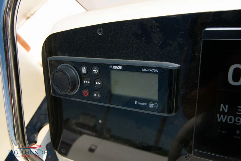 Slide: The Image of Close-up of the 2024 Capoforte SX200 boat's Fusion MS-RA70N audio system. - 20