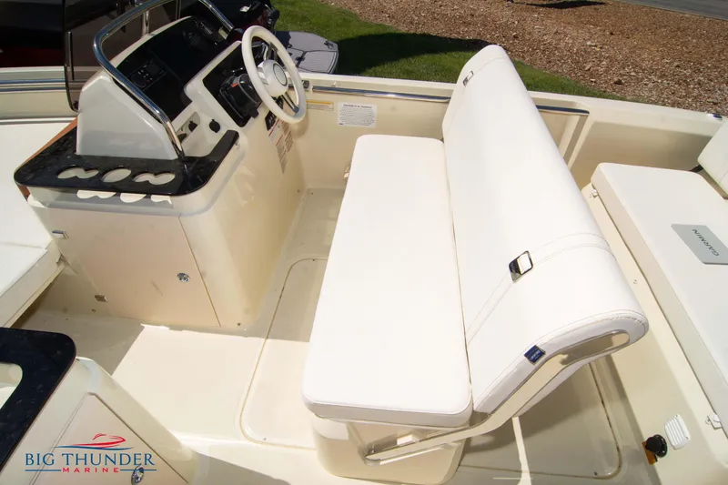 Slide: The Image of Capoforte SX200 2024 boat interior with white seating and steering console. - 24