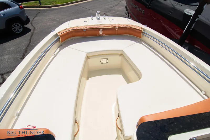 Slide: The Image of 2024 Capoforte SX200 boat bow seating area with tan cushions and storage compartment. - 30