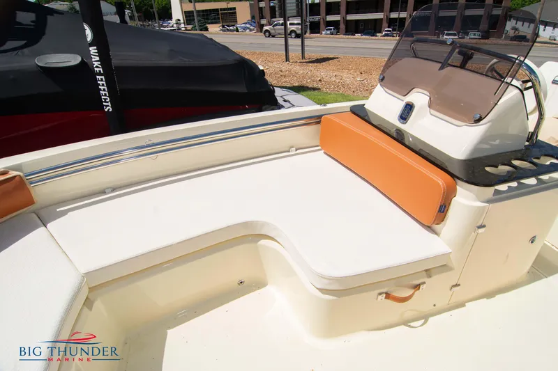 Slide: The Image of 2024 Capoforte SX200 boat interior with white and orange seating, displayed at Big Thunder Marine. - 31