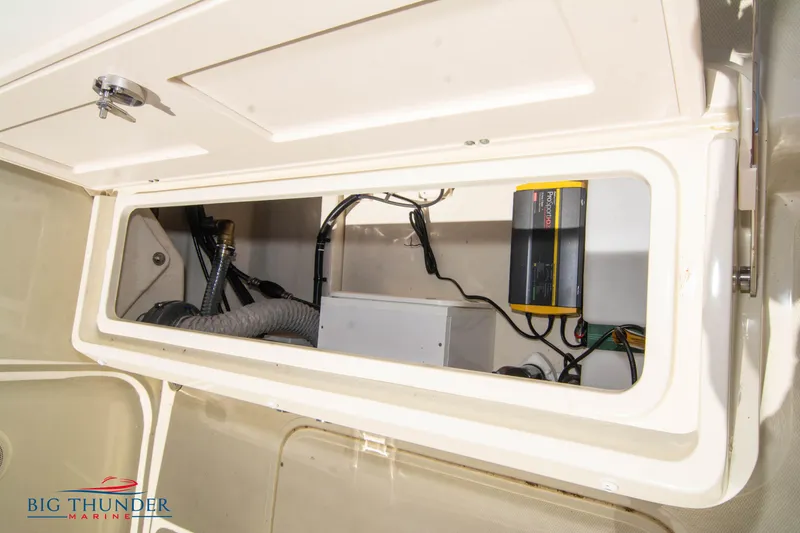 Slide: The Image of 2024 Capoforte SX200 boat storage compartment with electrical components. - 35
