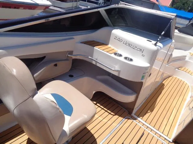 Slide: The Image of 1996 Four Winns 240 Horizon boat interior with seating and teak flooring. - 10