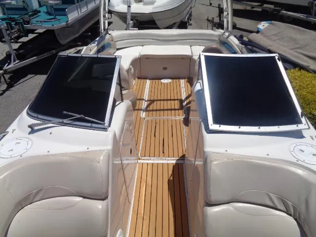 Slide: The Image of 1996 Four Winns 240 Horizon boat interior with teak flooring and white seating. - 17