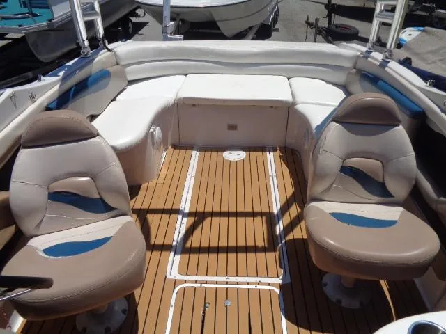 Slide: The Image of 1996 Four Winns 240 Horizon boat interior with seating and teak flooring. - 19