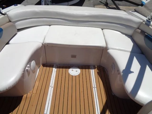 Slide: The Image of 1996 Four Winns 240 Horizon boat with white cushioned seating and teak flooring. - 20