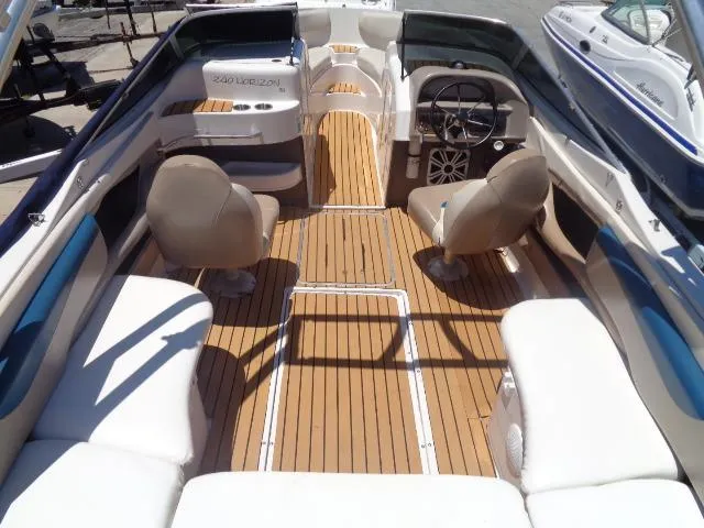 Slide: The Image of 1996 Four Winns 240 Horizon boat interior with teak flooring and beige seating. - 21