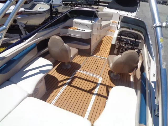 Slide: The Image of 1996 Four Winns 240 Horizon boat interior with seating and steering wheel. - 22