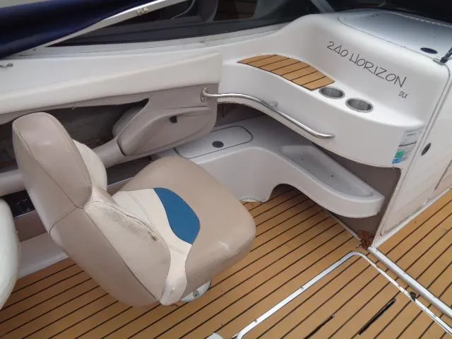 Slide: The Image of 1996 Four Winns 240 Horizon boat interior with captain's chair and dashboard. - 28