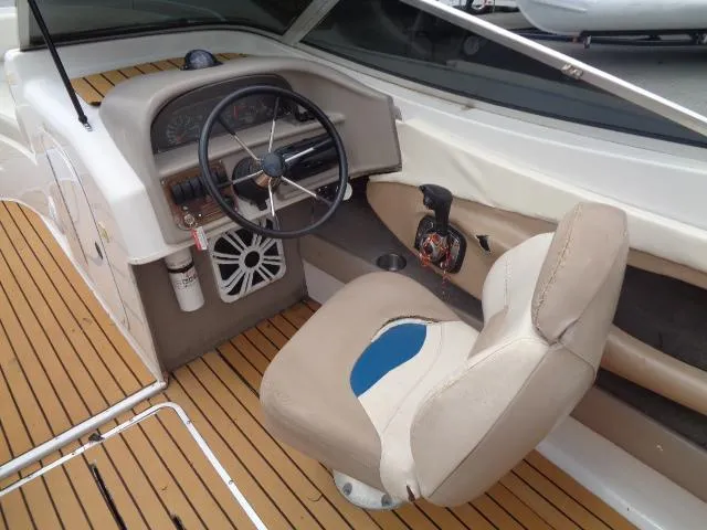 Slide: The Image of 1996 Four Winns 240 Horizon boat cockpit with steering wheel and captain's chair. - 29