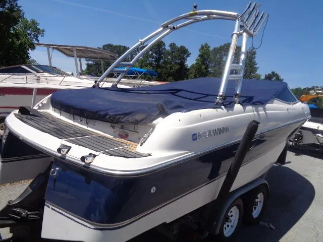 Slide: The Image of 1996 Four Winns 240 Horizon boat on trailer with blue cover. - 3