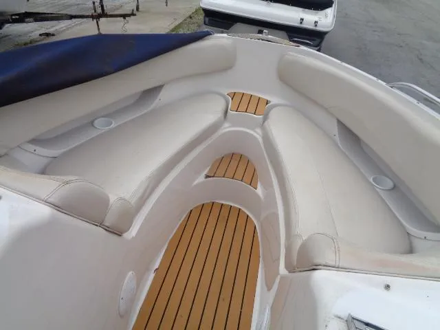 Slide: The Image of 1996 Four Winns 240 Horizon boat interior with white seating and wooden flooring. - 30