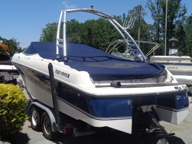 Slide: The Image of 1996 Four Winns 240 Horizon boat on trailer, covered and parked outdoors. - 5