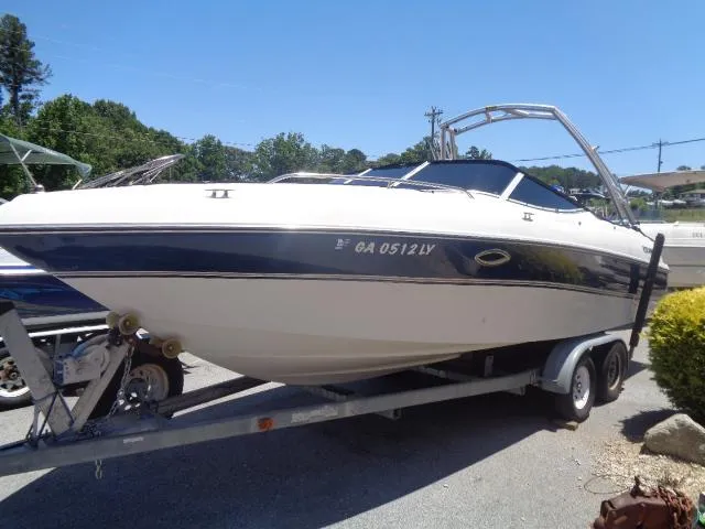 Slide: The Image of 1996 Four Winns 240 Horizon boat on a trailer in a parking lot. - 6
