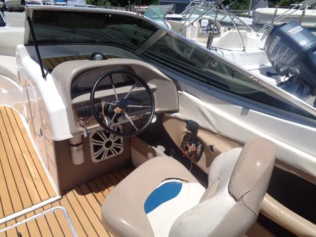 Slide: The Image of 1996 Four Winns 240 Horizon boat cockpit with steering wheel and seating. - 9