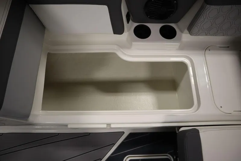 Slide: The Image of 2024 Heyday H22 boat interior storage compartment with cup holders and speaker. - 49