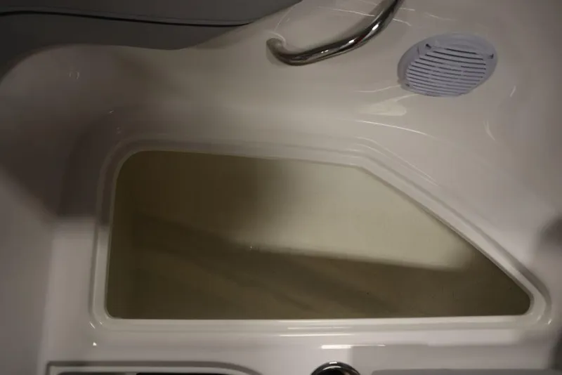 Slide: The Image of 2024 Bayliner VR4 Bowrider interior storage compartment with speaker and handrail. - 12