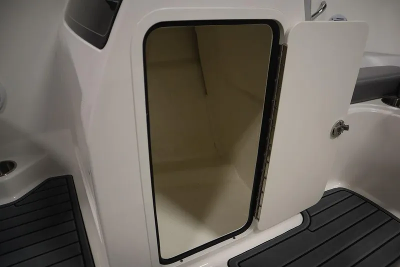 Slide: The Image of 2024 Bayliner VR4 Bowrider storage compartment with open door. - 13