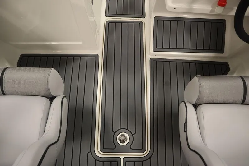 Slide: The Image of 2024 Bayliner VR4 Bowrider interior with gray cushioned seats and non-slip flooring. - 15