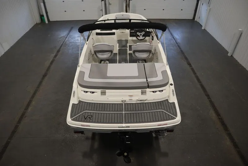 Slide: The Image of 2024 Bayliner VR4 Bowrider boat in a garage, rear view. - 16