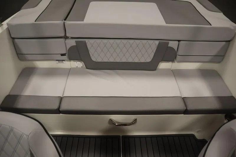Slide: The Image of 2024 Bayliner VR4 Bowrider interior seating with gray and white upholstery. - 18