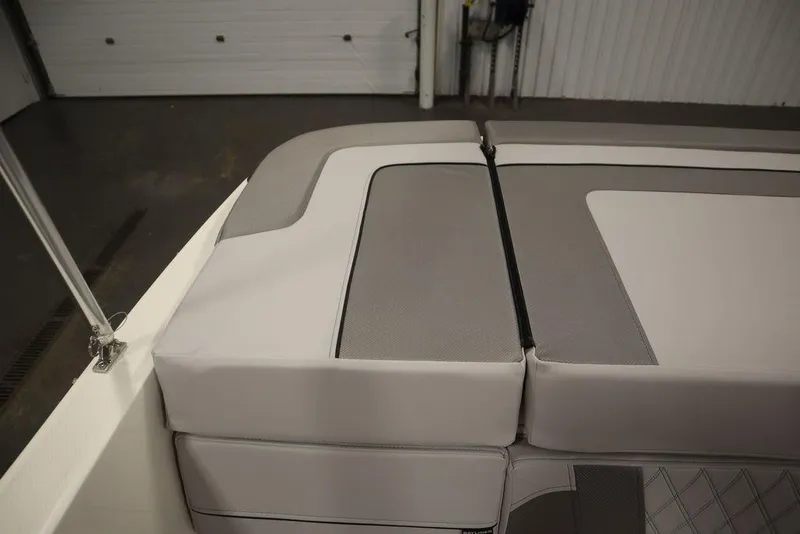 Slide: The Image of 2024 Bayliner VR4 Bowrider interior seating in a showroom. - 19
