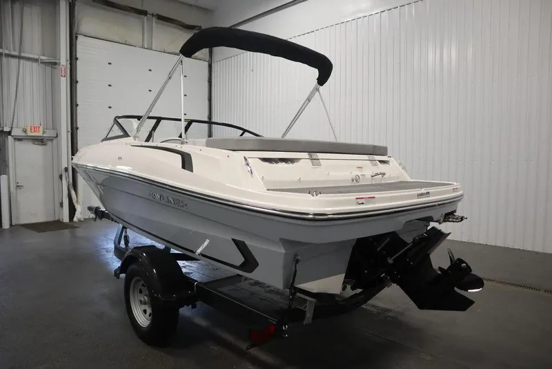 Slide: The Image of 2024 Bayliner VR4 Bowrider boat on trailer in indoor storage. - 21