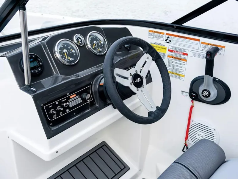 Slide: The Image of 2024 Bayliner VR4 Bowrider dashboard with steering wheel and control panel. - 26