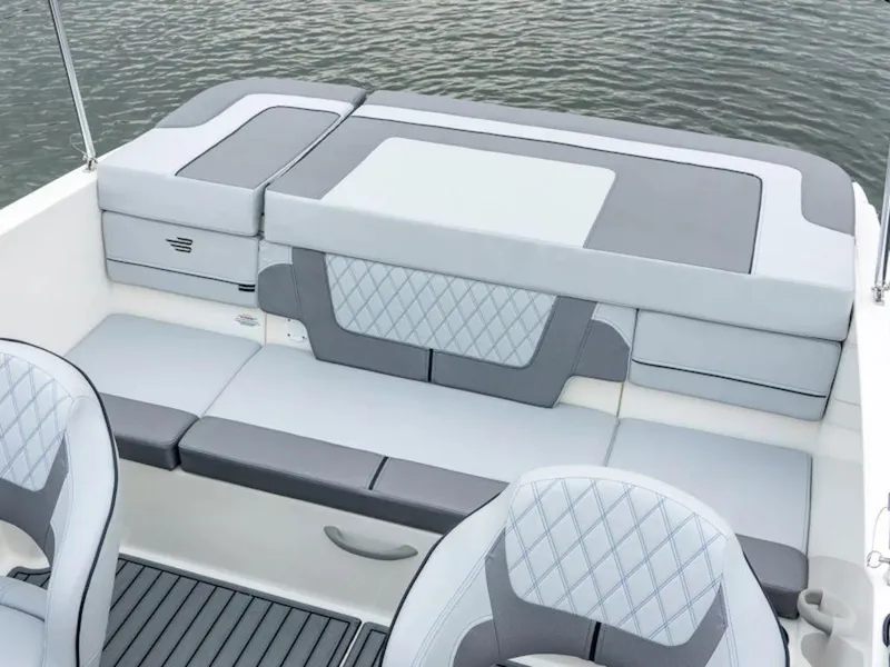 Slide: The Image of 2024 Bayliner VR4 Bowrider interior seating with gray and white upholstery. - 30