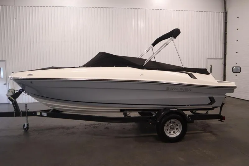 Slide: The Image of 2024 Bayliner VR4 Bowrider boat on trailer in indoor storage. - 35