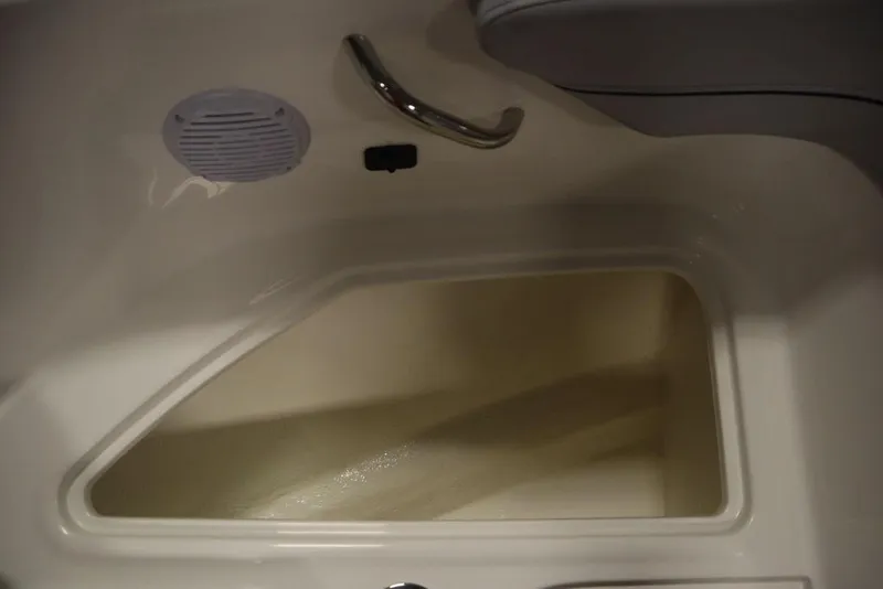 Slide: The Image of 2024 Bayliner VR4 Bowrider interior storage compartment with speaker and handle. - 49