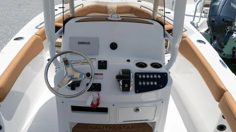 Slide: The Image of 2024 NauticStar 222 OSL boat console with steering wheel and controls. - 10