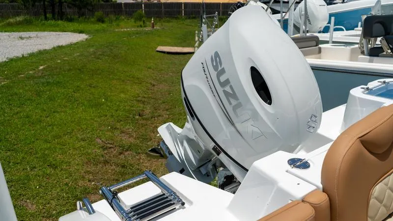 Slide: The Image of 2024 NauticStar 222 OSL boat with Suzuki outboard motor. - 14