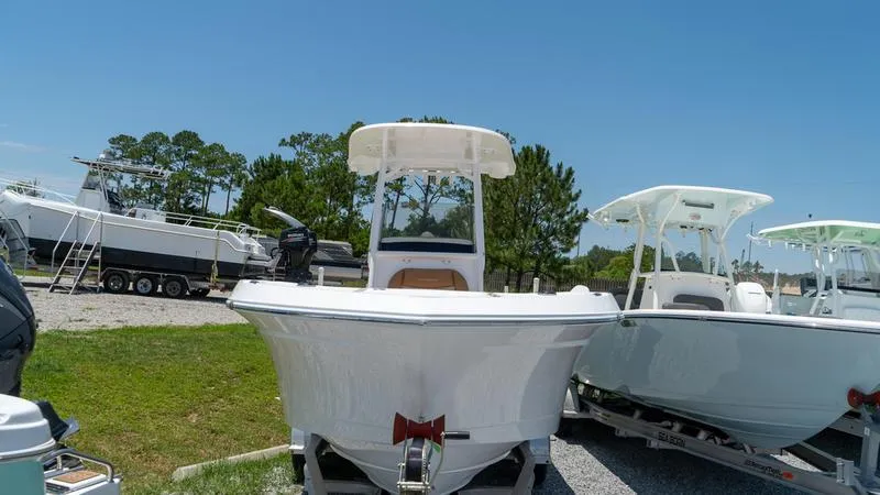 Slide: The Image of 2024 NauticStar 222 OSL boat on display in a marina. - 15
