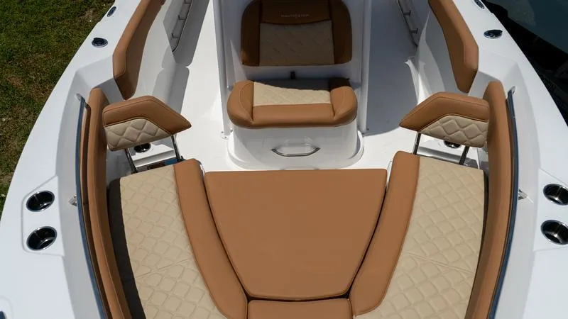 Slide: The Image of 2024 NauticStar 222 OSL boat with tan and beige cushioned seating. - 4