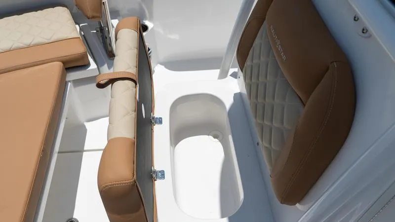 Slide: The Image of 2024 NauticStar 222 OSL boat interior with tan and white seating. - 5