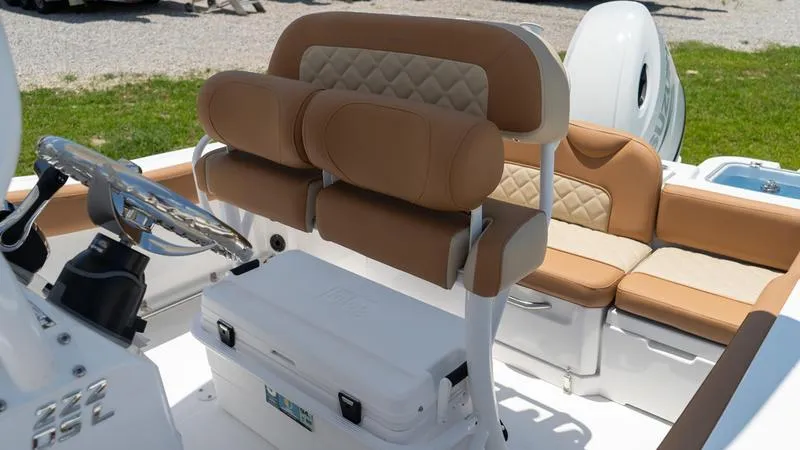 Slide: The Image of 2024 NauticStar 222 OSL boat interior with tan seating and steering console. - 6
