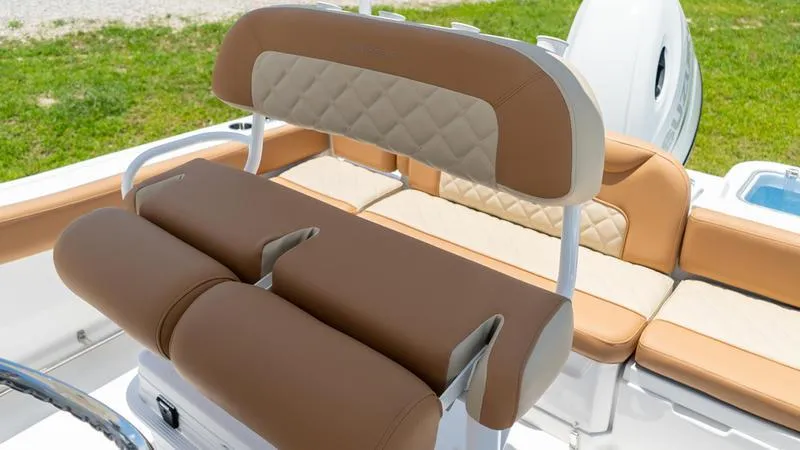 Slide: The Image of 2024 NauticStar 222 OSL boat with tan and cream cushioned seating. - 8