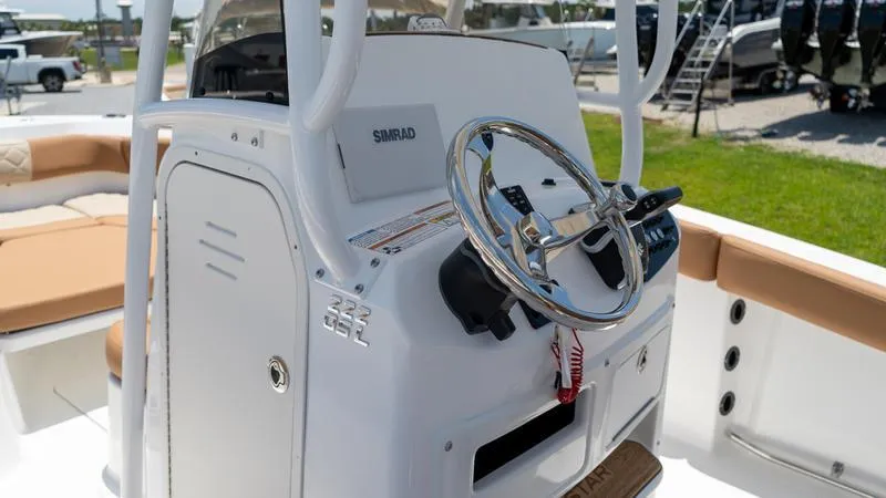 Slide: The Image of 2024 NauticStar 222 OSL boat console with steering wheel and Simrad electronics. - 9