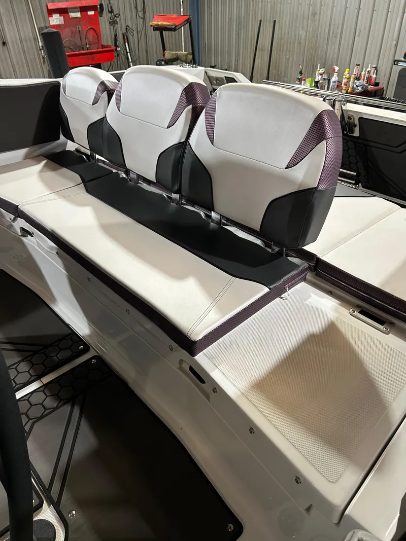 Slide: The Image of 2021 Scarab 255 Open ID boat interior with white and purple seating. - 10