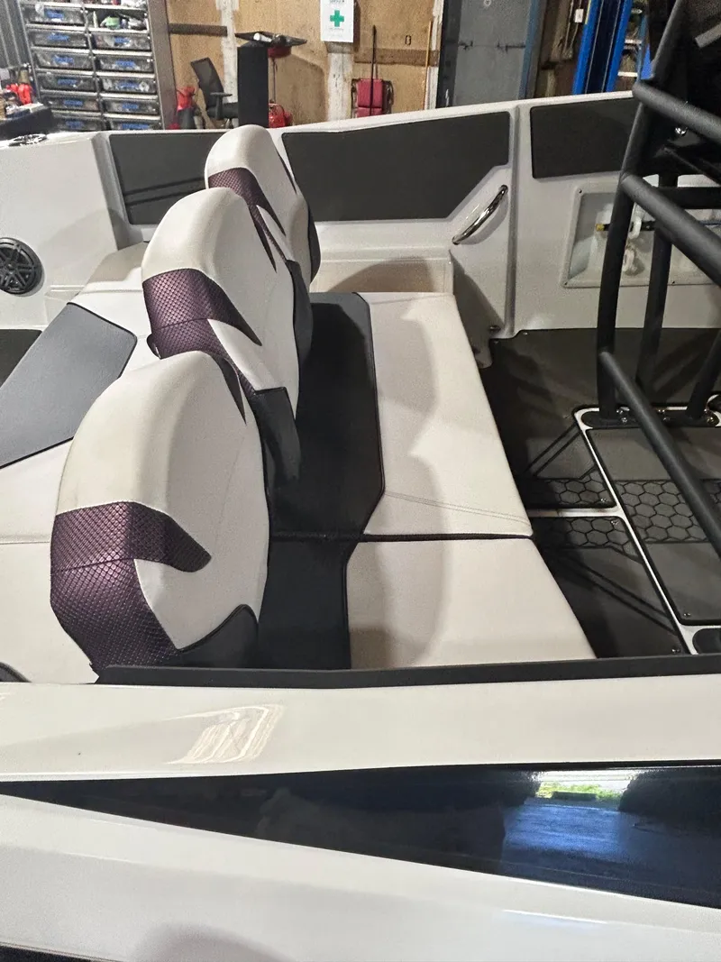 Slide: The Image of 2021 Scarab 255 Open ID boat interior with white and purple seats. - 14