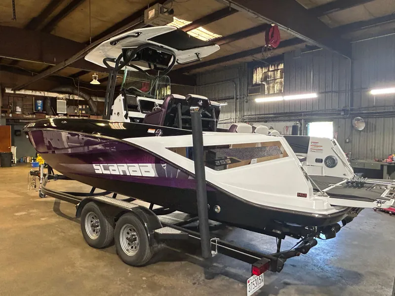 Slide: The Image of 2021 Scarab 255 Open ID boat on a trailer in a warehouse. - 4