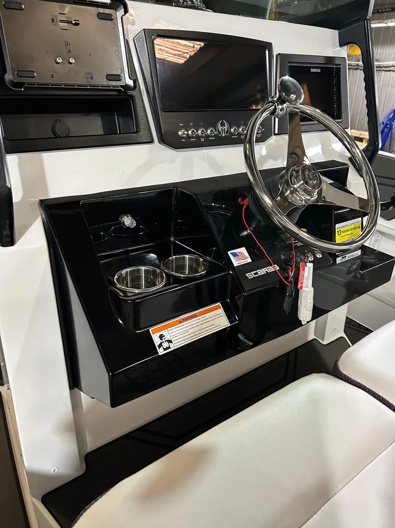 Slide: The Image of 2021 Scarab 255 Open ID boat dashboard with steering wheel and control panel. - 6