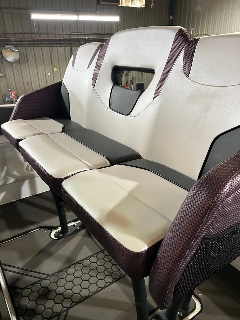 Slide: The Image of 2021 Scarab 255 Open ID boat seating in a warehouse. - 7