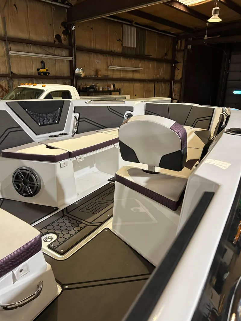 Slide: The Image of 2021 Scarab 255 Open ID boat interior in a garage. - 8